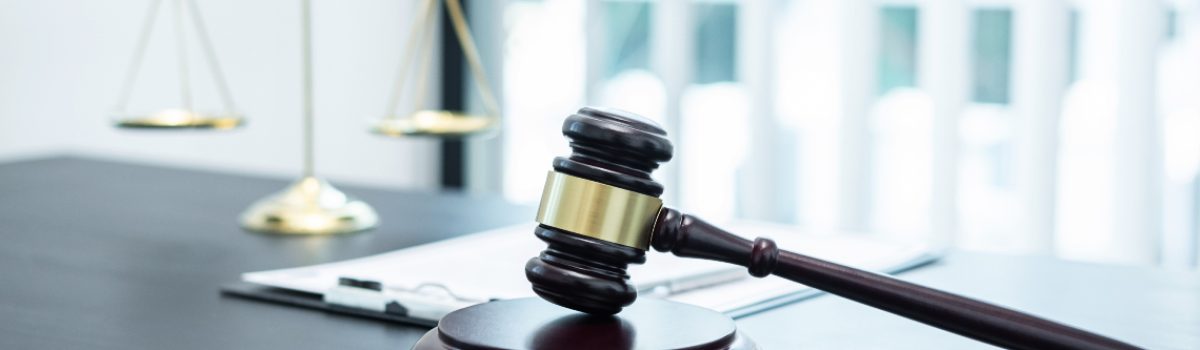 judge-gavel-with-justice-at-law-firm-in-background-2021-10-16-17-40-19-utc
